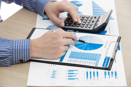 man hand with pen and business report. Accountingの写真素材