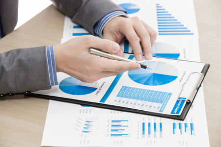 business report and man hand with pen. Accountingの写真素材