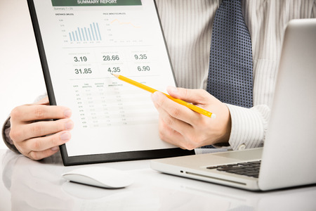 Businessman analyzing investment charts with laptop. Accountingの写真素材