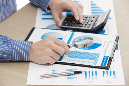 business report and man hand with pen. Accountingの写真素材