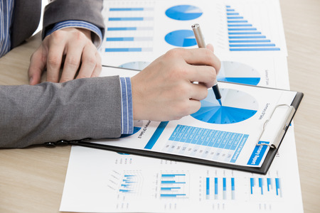 business report and man hand with pen. Accountingの写真素材