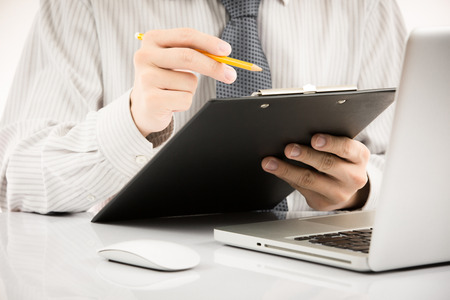 Businessman analyzing investment charts with laptop. Accountingの写真素材
