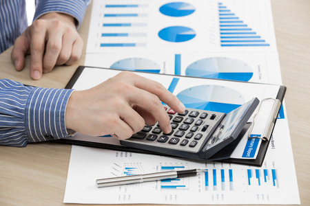 business report and man hand with pen. Accountingの写真素材