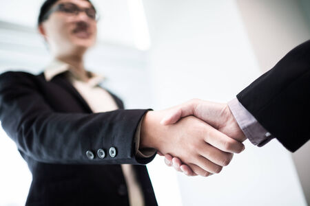 Close up of businessmen shaking handsの写真素材