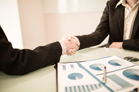 Close up of businessmen shaking handsの写真素材