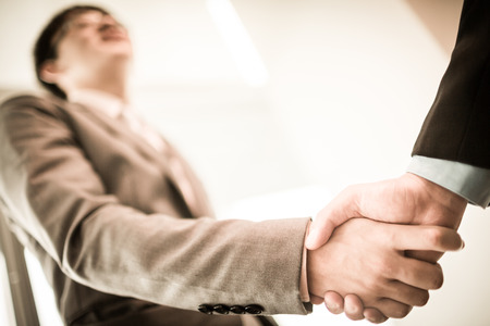 Close up of businessmen shaking handsの写真素材