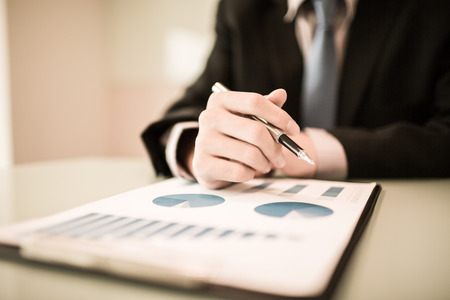 business report and man hand with pen. Accountingの写真素材
