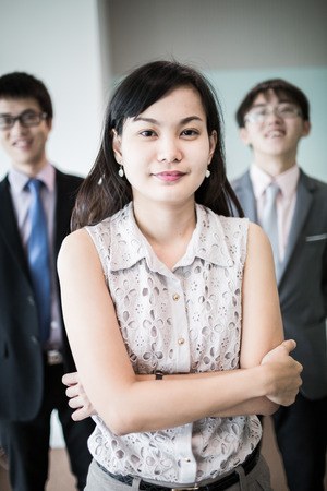 Happy business team with arms crossed at the office.Asianの写真素材