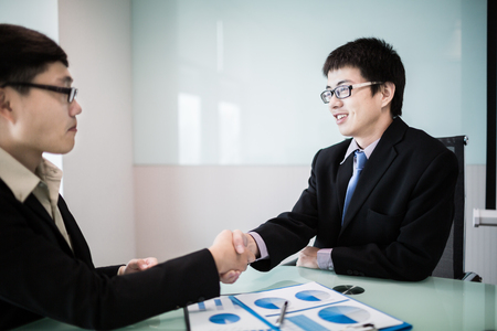 Close up of businessmen shaking handsの写真素材