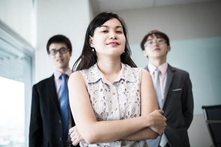 Happy business team with arms crossed at the office.Asianの写真素材