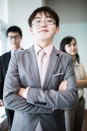 Happy business team with arms crossed at the office.Asianの写真素材