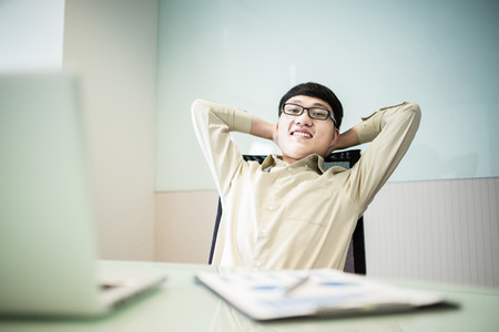 Young handsome man using laptop in his office.Asianの写真素材