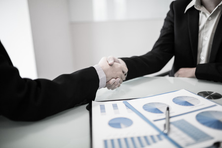 Close up of businessmen shaking handsの写真素材