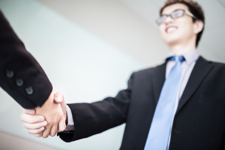 Close up of businessmen shaking handsの写真素材