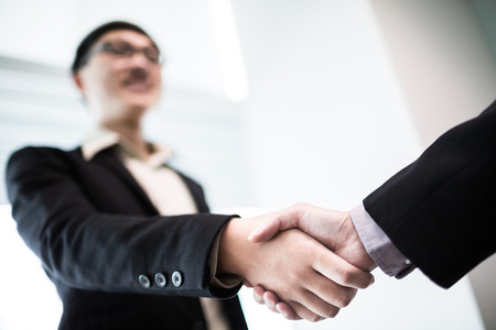 Close up of businessmen shaking handsの写真素材
