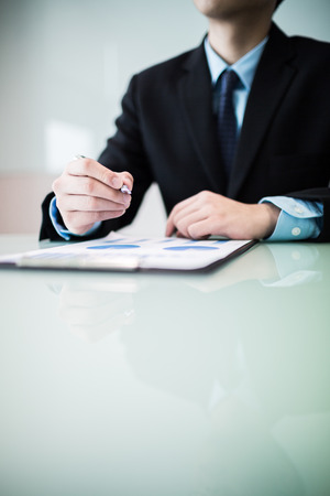 business report and man hand with pen. Accountingの写真素材