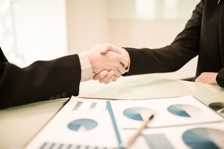 Close up of businessmen shaking handsの写真素材