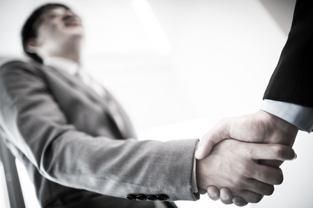 Close up of businessmen shaking handsの写真素材