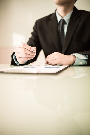 business report and man hand with pen. Accountingの写真素材