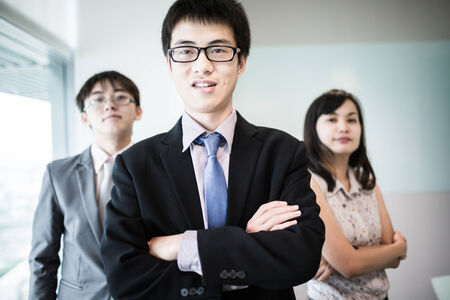 Happy business team with arms crossed at the office.Asianの写真素材