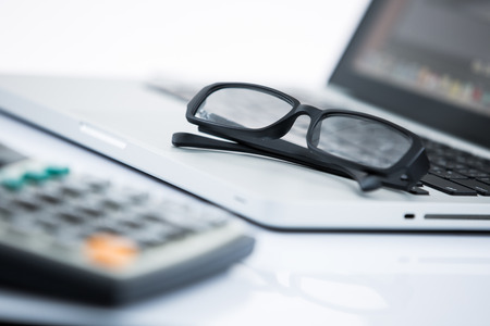 Office workplace with laptop and notepadの写真素材