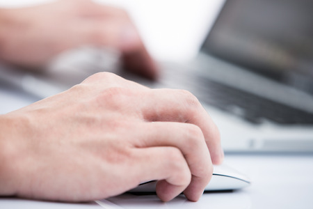 Hands of a man working with laptopの写真素材