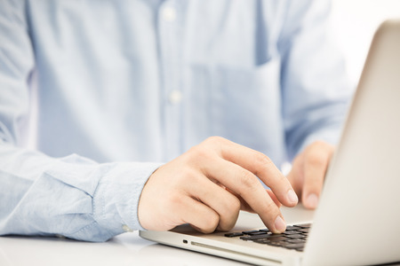 Hands of a man working with laptopの写真素材