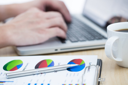 Businessman analyzing investment charts with laptop. Accountingの写真素材