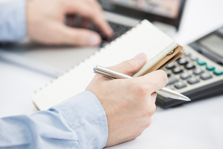 Businessman analyzing investment charts with laptop. Accountingの写真素材