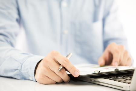 Businessman analyzing investment charts with laptop. Accountingの写真素材