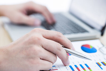 Businessman analyzing investment charts with laptop. Accountingの写真素材