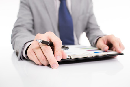 Businessman analyzing investment charts with laptop. の写真素材