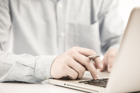 Hands of a man working with laptopの写真素材