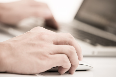 Hands of a man working with laptopの写真素材