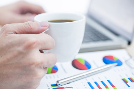 Businessman analyzing investment charts with laptop. Accountingの写真素材