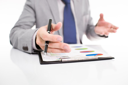 Businessman analyzing investment charts with laptop. の写真素材
