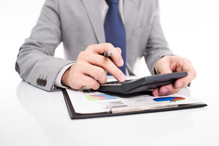 Businessman analyzing investment charts with laptop. の写真素材