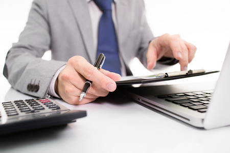 Businessman analyzing investment charts with laptop. の写真素材