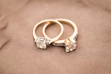 Wedding rings on brown の写真素材