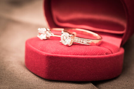 Wedding rings in a box on a brown の写真素材
