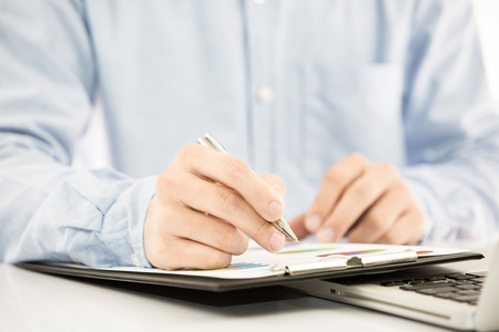 Businessman analyzing investment charts with laptop. Accountingの写真素材
