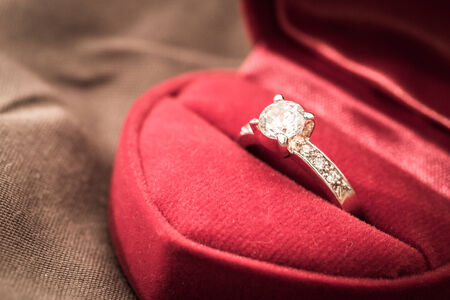 Wedding rings in a box on a brown の写真素材