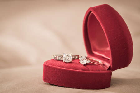 Wedding rings in a box on a brown の写真素材