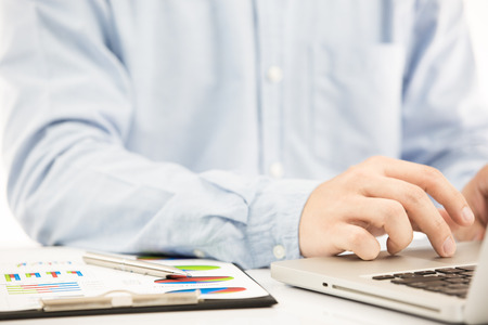 Businessman analyzing investment charts with laptop. Accountingの写真素材