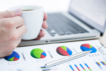 Businessman analyzing investment charts with laptop. Accountingの写真素材