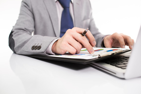 Businessman analyzing investment charts with laptop. Accountingの写真素材