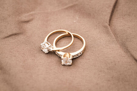 Wedding rings on brown backgroundの写真素材