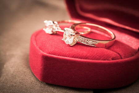 Wedding rings in a box on a brown backgroundの写真素材