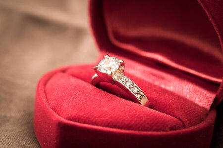 Wedding rings in a box on a brown backgroundの写真素材