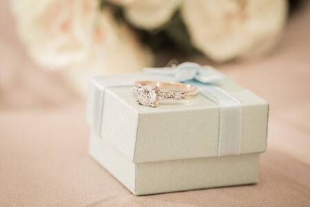 Wedding rings in a box on a brown backgroundの写真素材